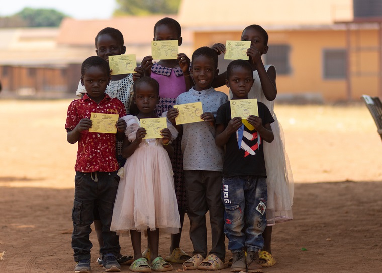 予防接種カードを手に笑顔を見せる子どもたち。<br> 西エクアトリア州では予防接種キャンペーンを通して、黄熱病への積極的なワクチン接種に踏み出した＝2024年2月18日　© MSF/Isaac Buay