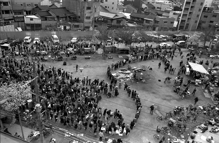 西成区のあいりん地区、通称「釜ケ崎」の三角公園でボランティアの炊き出しに並ぶ人々＝1999年、大阪市で渋谷敦志撮影