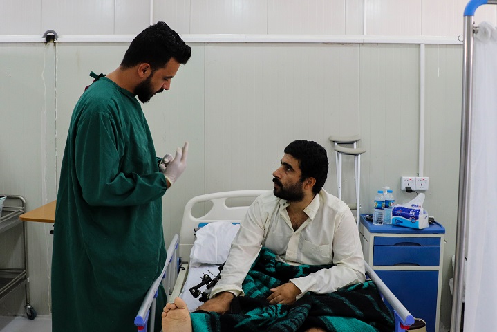 MSFの看護師と話す薬剤耐性菌感染症になった患者（左）© Elisa Fourt/MSF