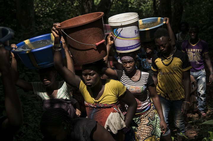 バケツで水を運ぶシエラレオネの女性たち　© Xaume Olleros
