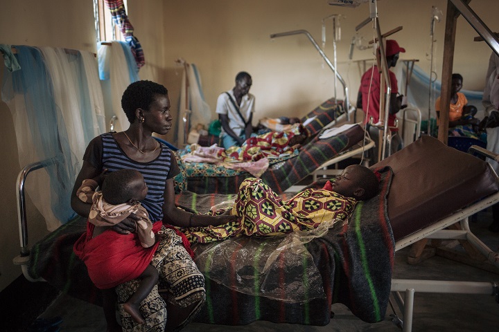 はしかで苦しむ娘を見守る母親(左) © Alexis Huguet/MSF