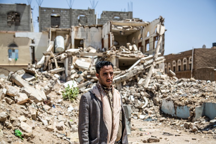 イエメンで空爆により破壊された自宅の前に立つ男性　🄫 Agnes Varraine-Leca/MSF