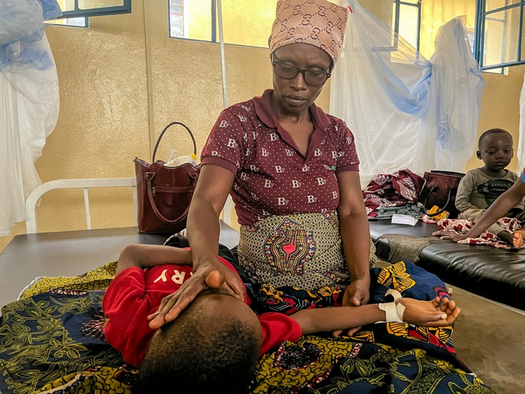 MSFが支援するチビトケ地域病院で、マラリアの治療を受ける9歳の男の子とその母親=2025年5月15日 © Dorine Niyungeko/MSF