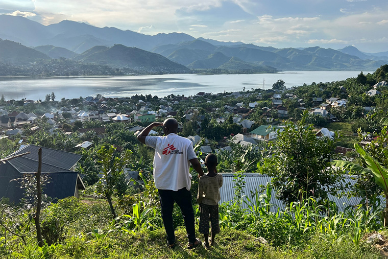 丘の上からキブ湖を眺めるMSFのスタッフと子ども © Igor Barbero/MSF