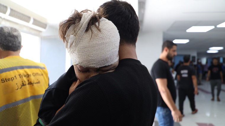 空爆で負傷し、アル・シファ病院で手当てを受けた少年と父親＝2023年10月19日 © Mohammad Masri